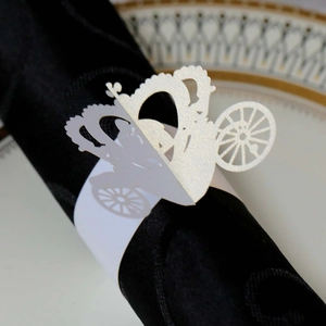 Laser-cut white pumpkin carriage paper napkin ring with intricate hollow details for weddings