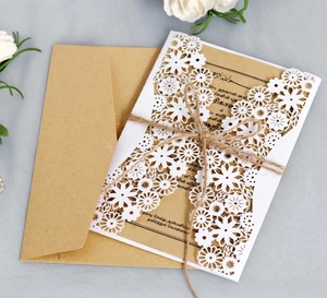 Laser cut white floral wedding invitation set with kraft paper card and hemp rope