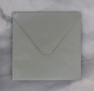 Detailed view of light grey square envelope with pearlescent finish and V-flap closure