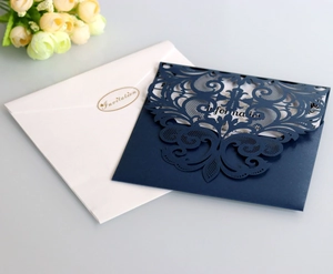 Détail de l'invitation bleu marine découpée au laser avec motifs baroques et sceau d'or