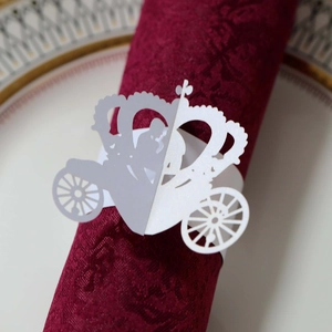 Laser-cut white paper napkin ring featuring a detailed pumpkin carriage and crown design