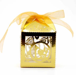 Elegant gold laser-cut LOVE wedding candy box with ribbon bow and intricate heart patterns