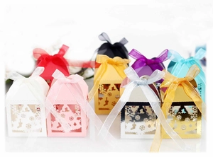 Detailed laser-cut Christmas tree candy boxes in multiple colors with silk ribbon bows