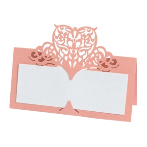 Macro view of laser-cut pink glitter place card with heart detail for weddings
