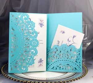 Detailed laser-cut Tiffany blue wedding invitation set with floral inner card on tray