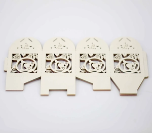 Detailed macro view of laser-cut wedding candy box panels with heart and ring patterns