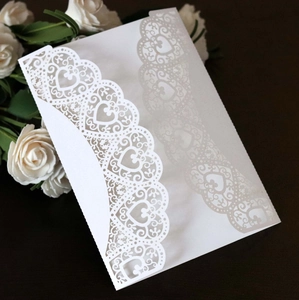 Elegant white laser-cut heart wedding invitation with pearl finish and floral lace design