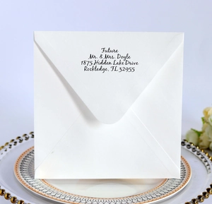 Square white envelope for wedding with elegant calligraphy address and gold plate
