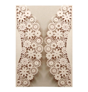 Detailed laser-cut champagne pearlescent paper wedding invitation with floral patterns