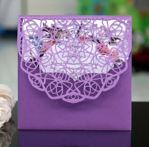 Detail of laser-cut purple mandala wedding invitation with floral printed inner card