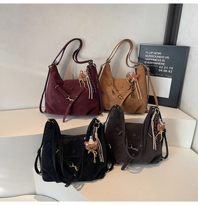 Close-up of vintage matte leather crossbody bags in four colors with bear charms