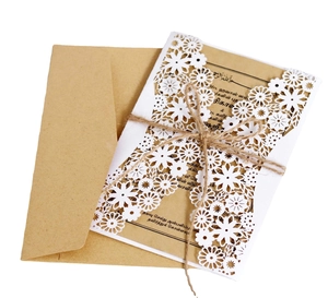 Laser cut white wedding invitation set with brown kraft envelope and jute twine bow