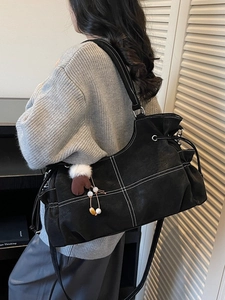 Black large tote bag with white contrast stitching and a cute brown glove charm