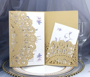 Detail showing laser-cut lace pattern on gold wedding invitation with floral insert