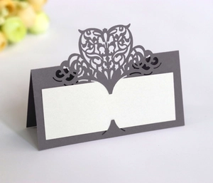 Detail of laser-cut heart seat card with intricate patterns for wedding table settings