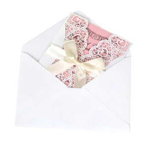 Lace wedding card with laser-cut hearts, pink insert, and white silk ribbon bow