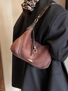 Brown suede hobo shoulder bag with white contrast stitching and gold ring hardware