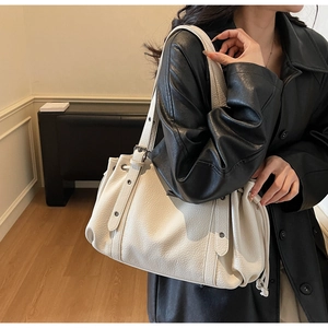 Close-up of cream white tote bag with lychee grain texture and drawstring design