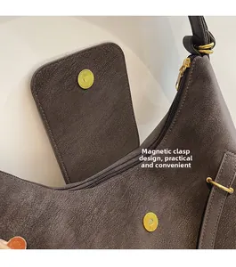 Detail view of the secure magnetic clasp and premium textured leather on a tote bag