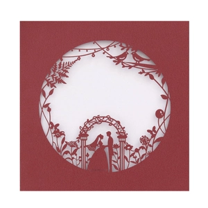 Elegant laser-cut wedding invitation in deep burgundy paper with ornate floral silhouette
