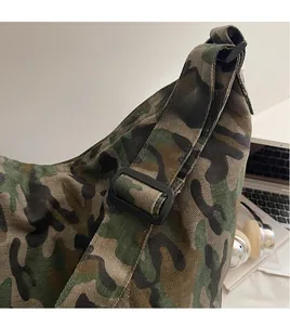 Detail view of durable camouflage canvas tote featuring adjustable wide shoulder strap buckle