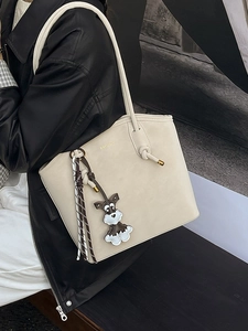 Chic cream white bucket tote bag for women featuring a cute puppy charm and scarf detail
