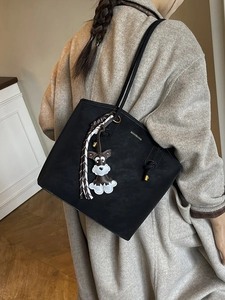 Fashionable black matte bucket tote bag with schnauzer charm and striped scarf detail