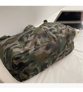 Detail of military green camo canvas tote bag showing soft woven fabric texture