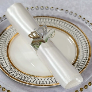 Silver pumpkin carriage napkin ring on white satin napkin for elegant wedding table decor