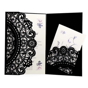 Elegant black laser cut wedding invitation suite with intricate lace design and floral card