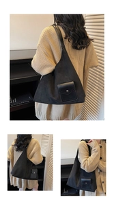 Detail of black matte leather tote bag featuring a front pocket with metallic magnetic buckle