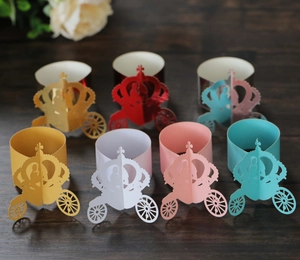 Macro detail of laser-cut 3D crown carriage paper napkin rings in various colors