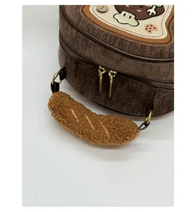 Detail of plush corduroy material and bread-shaped embroidery on a cute brown tote bag
