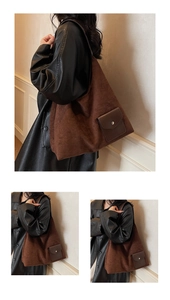 Detail view of large dark brown suede tote bag featuring a leather flap pocket with metal snap