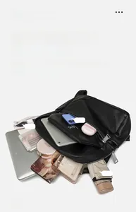Macro view of large black litchi texture backpack showing spacious interior capacity