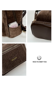 Detail of dark brown corduroy backpack showing side pocket and bone shaped logo patch