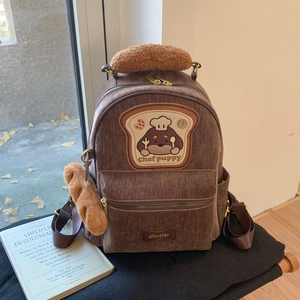 Detail of brown corduroy backpack with Chef Puppy embroidery and lamb wool handle grip