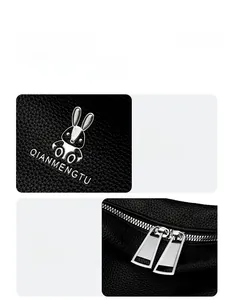 Detail of lychee pattern leather backpack with silver rabbit logo and two-way zippers