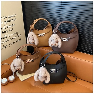 Detailed view of leather moon bags in four colors with cute plush rabbit charms