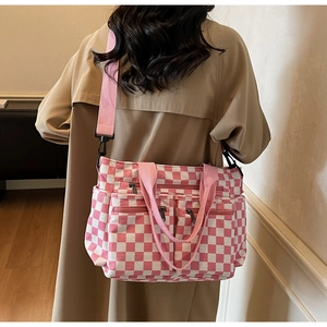 Pink and white checkered canvas tote bag with multi-pocket design and adjustable shoulder strap