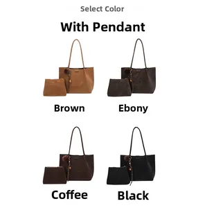 Detail view of large tote bags in four colors with matching coin purses and pom-pom charms