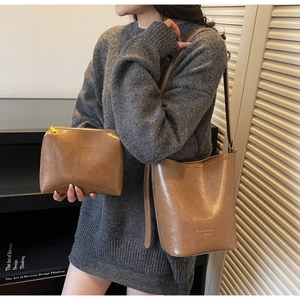 On-body shot of retro caramel bucket bag set with matching pouch and slim strap