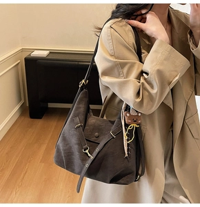 Detail of vintage large capacity dark brown tote bag with bear charm on model