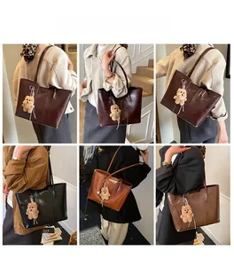 Collage of large tote bags in burgundy, black, brown, and yellow with plush bear charms