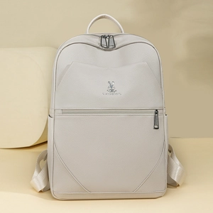 Detailed macro view of the cream-white litchi grain leather texture and rabbit logo