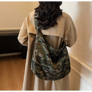 Detail view of large capacity camouflage canvas tote bag with wide shoulder strap