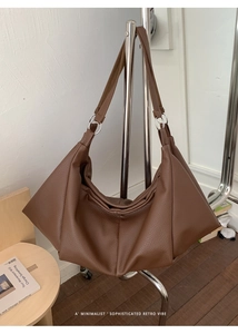 Close-up of the vintage brown leather tote bag with metal ring strap connectors
