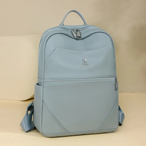 Close-up of light blue lychee pattern leather backpack with silver rabbit logo detail