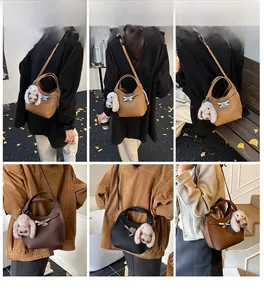 Collage of leather bucket bags in three colors worn by model featuring rabbit charms