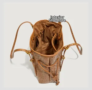 Detail view of brown tote bag interior with ostrich pattern and multi-pockets